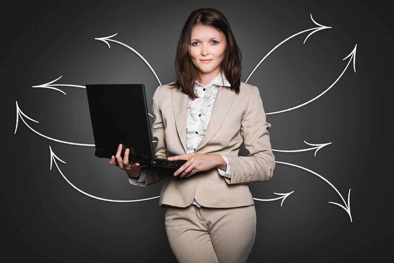 Female consultant standing with laptop